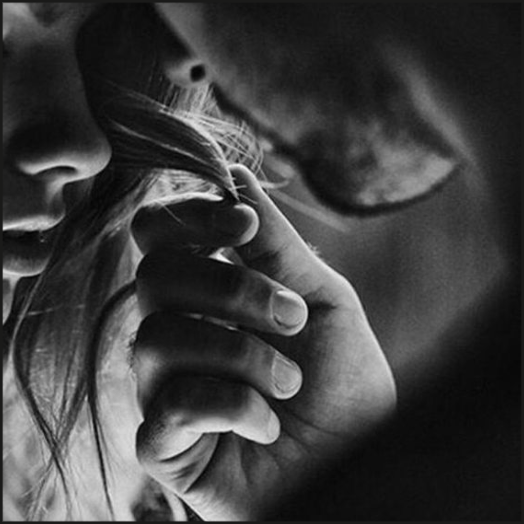 Man caressing woman's hair as their faces are close